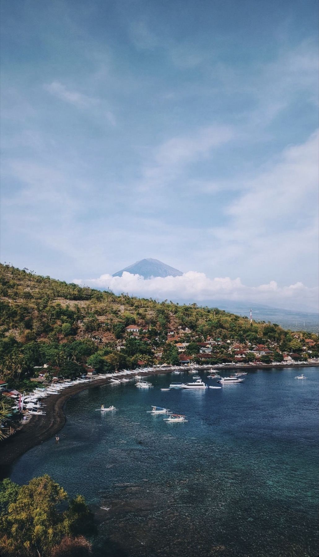Amed coastline and bay with Mount Agung behind the clouds